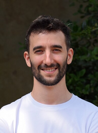 Photo of speaker Tomas Francisco, smiling, in a white tee